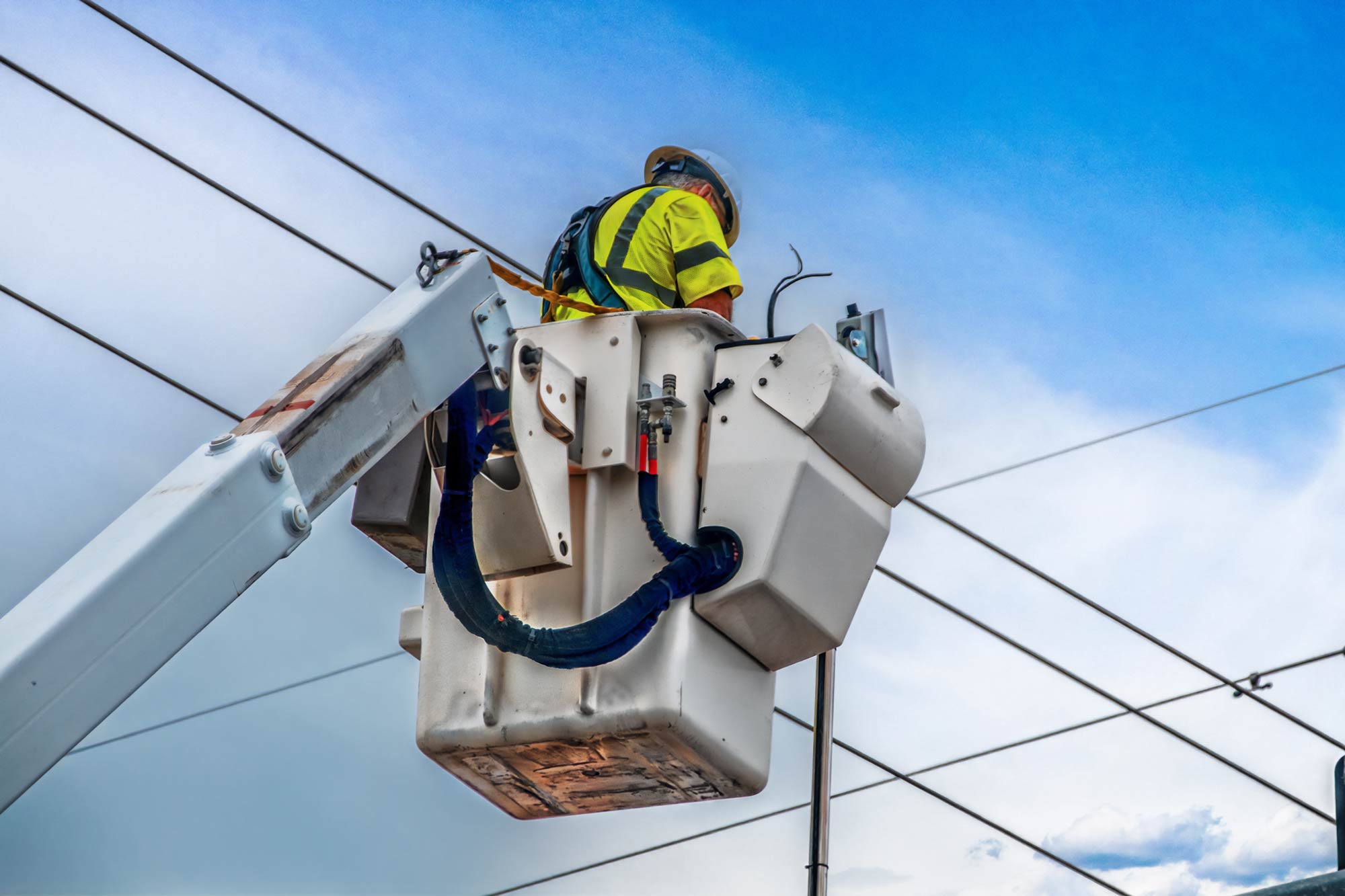 Electrical Lineman Working on Lines from a bucket truck