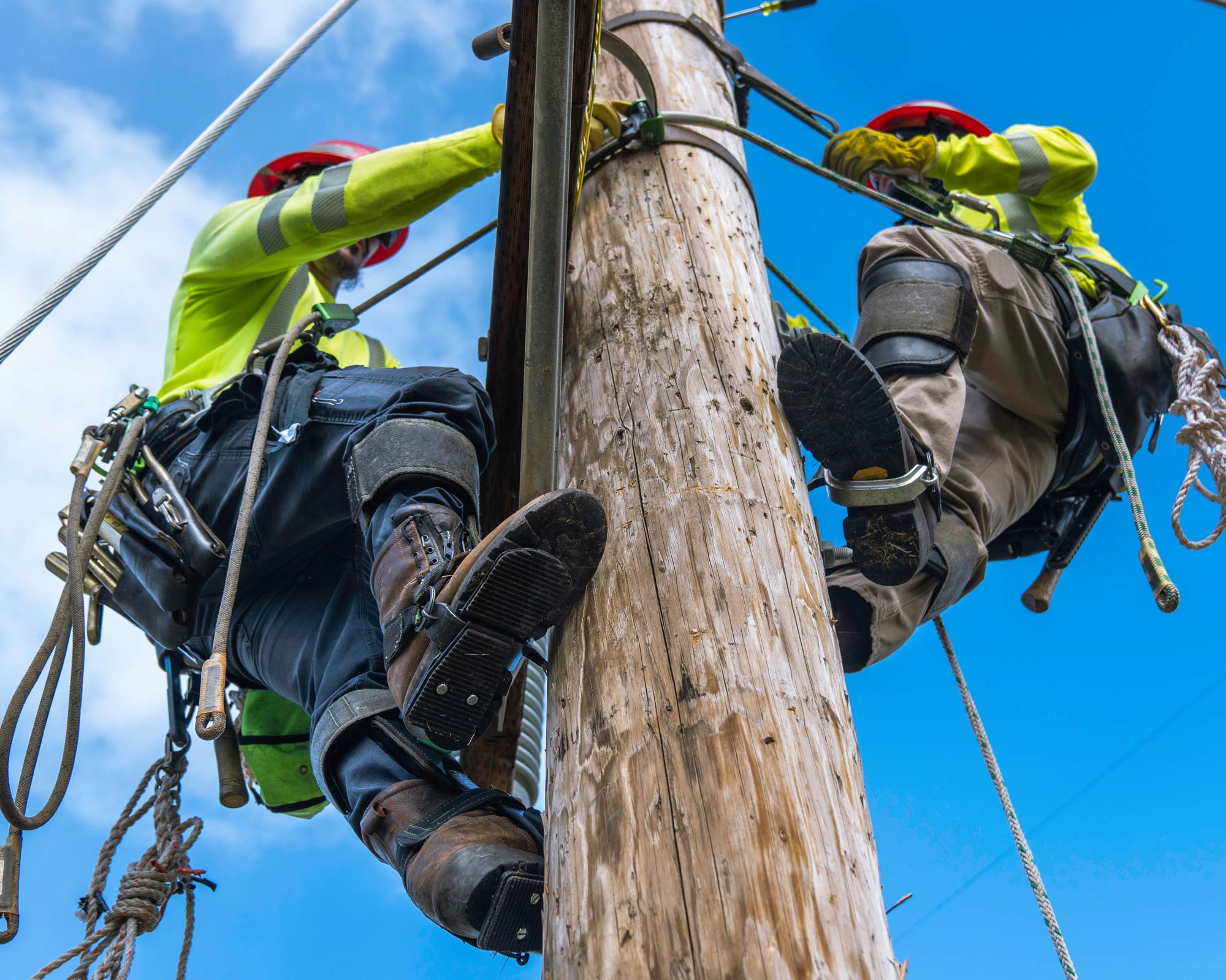 Two IBEW Linemen Climbing a Pole to Make Repairs | IBEW Local 71